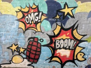 omg! and boom grafitti on wall
