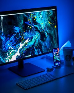 flat screen computer monitor turned on beside black keyboard