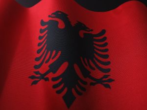 a close up of a red and black flag