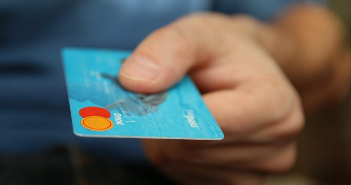 person holding debit card